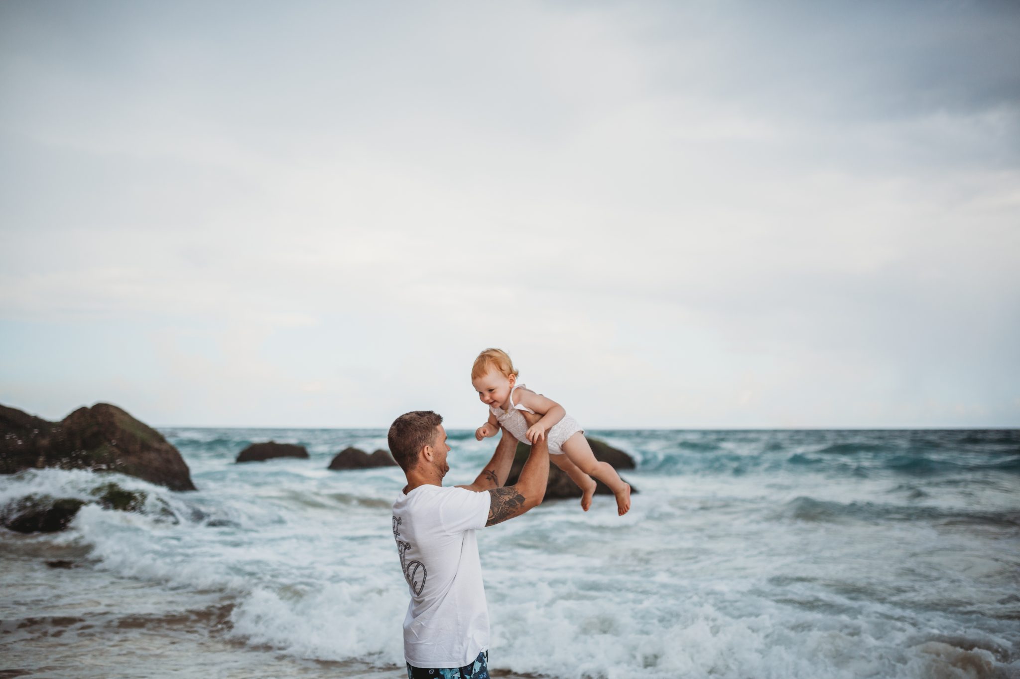 Father lifting daughter into the air