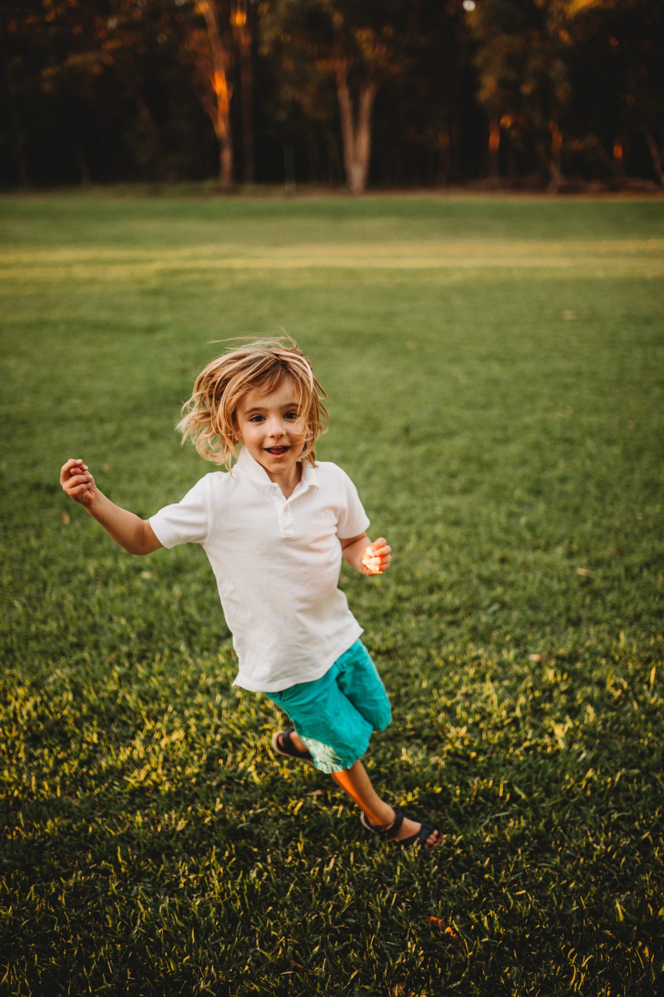 Action shot of young boy running while looking at camera