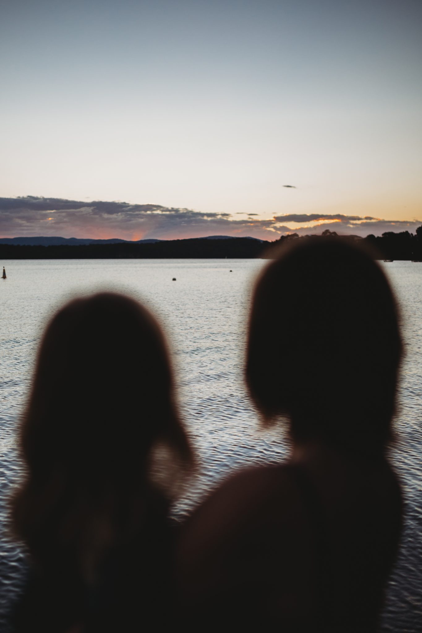 Mother and daughter silhouette at Lake Macquarie at sunset