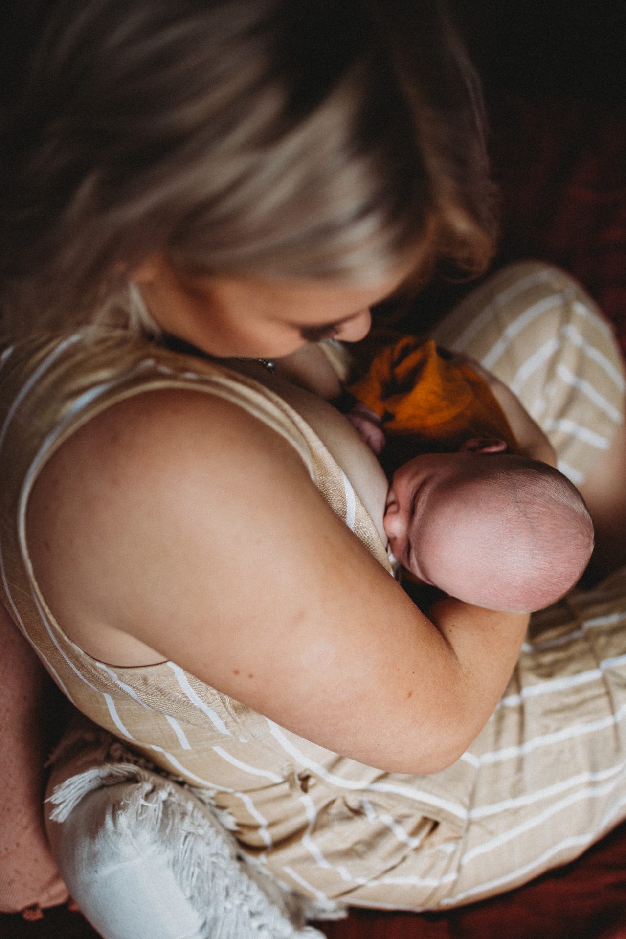 Mother breastfeeding newborn son